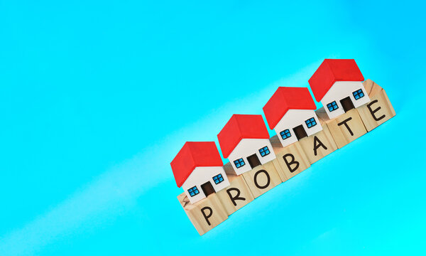 Miniature houses rising on probate letter blocks representing estate value growth, inheritance and property progression.
