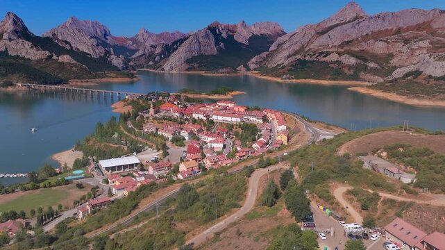 Summer rural tourism in the village of Ria&ntilde;o in Le&oacute;n, Spain. Aerial view of riano village on lake peninsula in spain