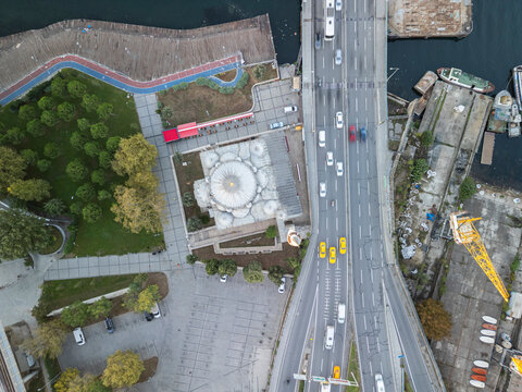 Turkey, Istanbul 06 10 2025: Vertical top-down drone photo of Sokullu Mehmet Pasha Mosque with Ataturk Bridge aligned vertically alongside Halic shipyard fountain.