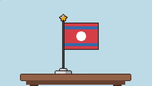 Pixel art style national flag of Laos placed on a small stand over a wooden table against a light blue background.