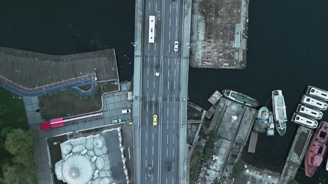 Turkey, Istanbul 06 10 2025: 4K top-down drone video moving along vertically aligned Ataturk Bridge from Sokullu Mehmet Pasha Mosque out over sea water with active traffic.