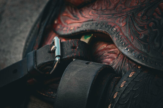 closeup of leather breast collar and girth on western saddle