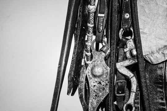 closeup of western bits and bridles and denim jeans