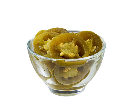 marinated jalapeno in a glass bowl isolated on a white background. clear glass bowl with pickled jalapeno isolated.