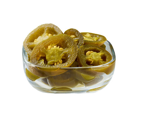 pickled jalapeno in a transparent glass bowl isolated on a white background. Glass bowl with marinated jalapeno isolated.