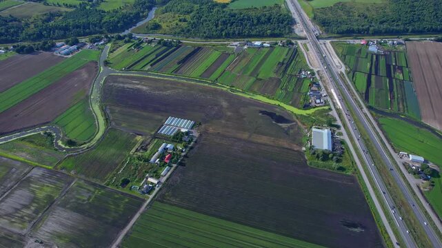 Aerial view of agricultural farms and crops fields. Agricultural landscapes from above. Soil with planted vegetables. Planting rows of crops for harvesting. Designated Specialty Crop Area.