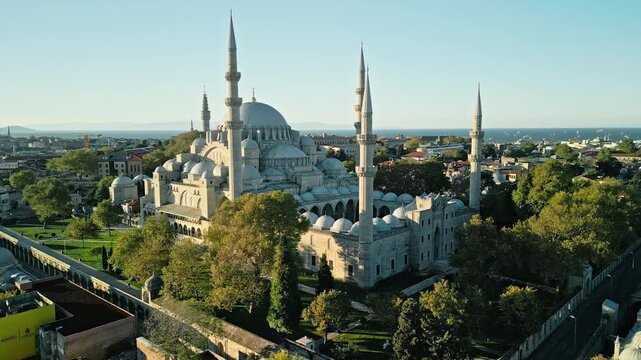 Turkey, Istanbul 06 10 2025: 4K arc drone video orbiting Suleymaniye Mosque domes and minarets at sunrise, ending in a perfectly symmetrical frontal view.