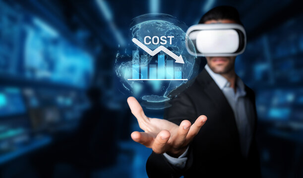 A businessman using virtual reality headgear to visualize cost reduction strategies, illustrating efficiency and budget management in a corporate setting focused on innovation. XDMCP