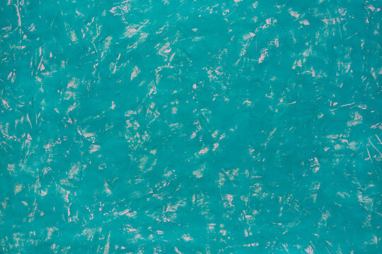 Vibrant turquoise surface with textured, glossy finish. Natural patterns ripple like water or wet clay. Ideal backdrop for design, branding, or artistic projects