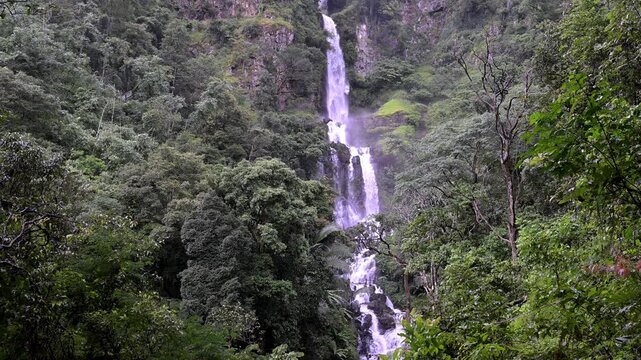 Huai Nam Yen Waterfall cascading through lush tropical rainforest in the rainy season in Omkoi District Chiang Mai, Thailand