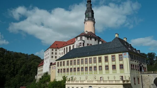 Historic castle complex with clock tower and formal gardens