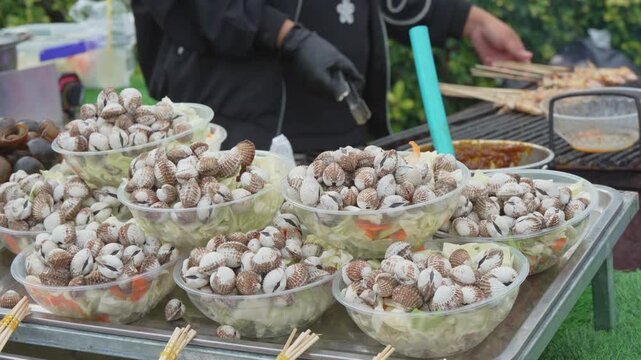 Assorted seafood skewers displayed at a street market