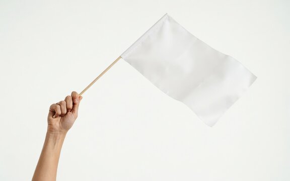 Hand holding a white flag isolated on white background