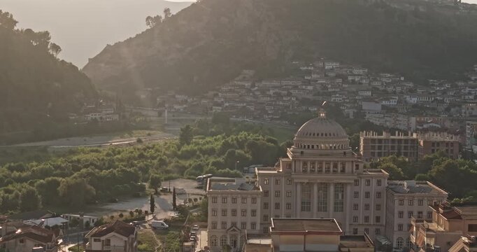 Berat Albania Aerial v17 zoomed 3x low flyover toward Hotel Colombo, capturing downtown residences, cityscape and castle hillside at sunset - Shot with 5k Camera - July 11th 2024