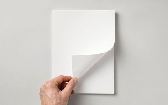 Hand turning a blank white paper page
