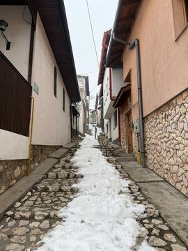 Long exposure view of historic narrow cobblestone street with traditional Ottoman houses and wooden bay windows in Vratnik Old Town Sarajevo Bosnia