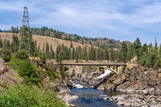 The Little Falls Dam spillway behind an arch bridge over the Spokane River near Reardan, Washington, USA