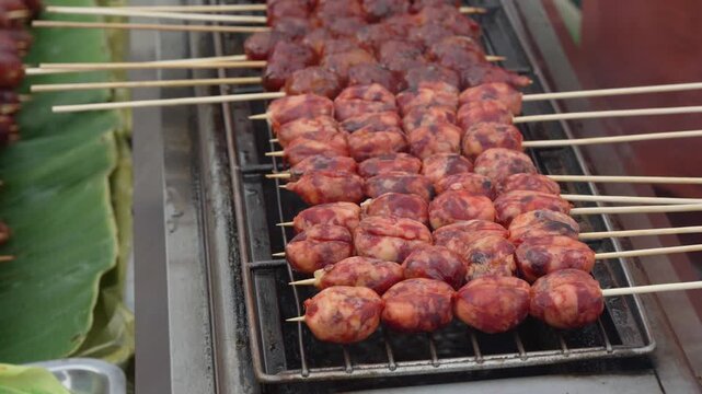 Close up of grilled meatball skewers on barbecue