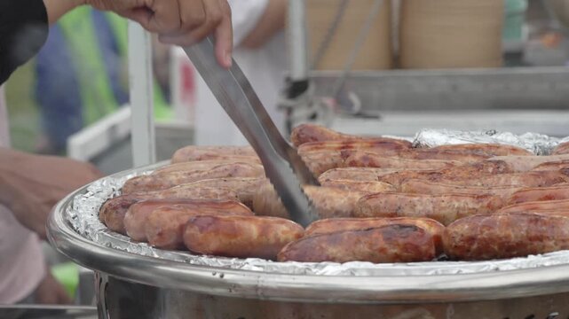 Grilled meat skewers cooking on a street food barbecue