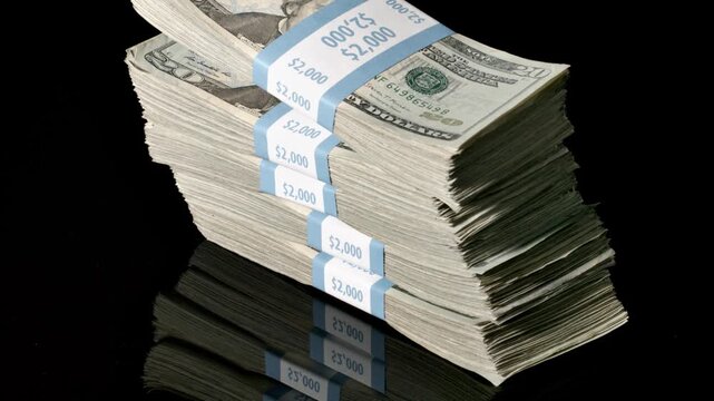 Stack of money falling and landing on a table. Slow Motion.