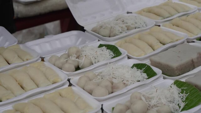 Assorted steamed dumplings and vegetables at a food market