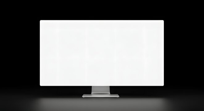 A modern minimalist computer monitor with a wide screen displaying a solid glowing bright white light, sitting on a clean dark desk surface. The monitor has a thin bezel and a sleek silver stand