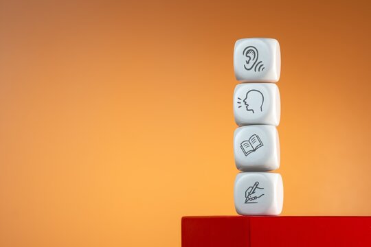 Stacked white cubes with listening, speaking, reading, and writing icons. Language learning, communication skills, education concept.