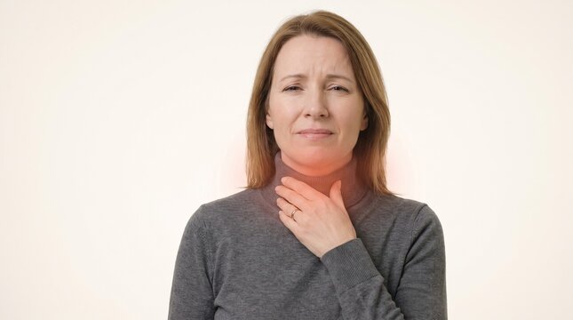 Middle Aged Woman Suffering From Sore Throat With Red Pain Area