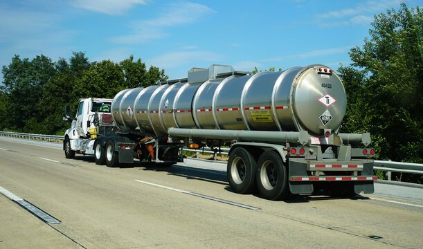 Middletown, Delaware, U.S.A - Sept 9, 2026 - A silver tanker truck transporting hazardous material along Route 1 highway with placard 2672.