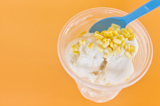 Coconut ice cream cup with mung beans on orange
