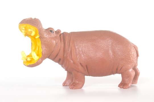 Toy hippo figurine open mouth side view isolated on white