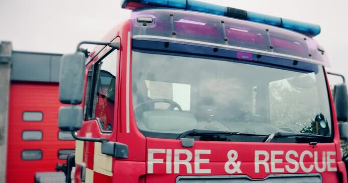 Fire truck emergency service vehicle at fire station. Red fire engine with ladders, firefighting apparatus and water to save lives, rescue victims, extinguish fires and assist vehicle collision.