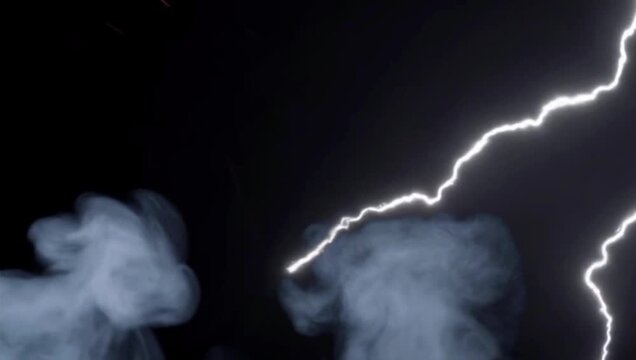 Intense lightning bolts striking through thick swirling smoke clouds in this dramatic dark motion video clip