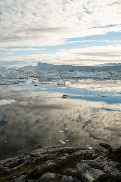 Iceberg and ice from glacier in arctic nature landscape on Greenland. Aerial photo drone photo of icebergs in Ilulissat icefjord. Affected by climate change and global warming