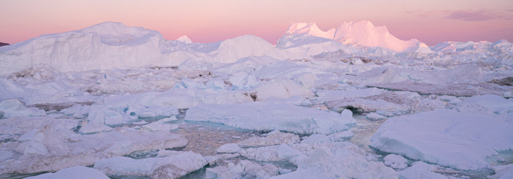 Iceberg from glacier in arctic nature landscape on Greenland. Aerial photo drone footage of icebergs in Ilulissat icefjord. Affected by climate change and global warming.