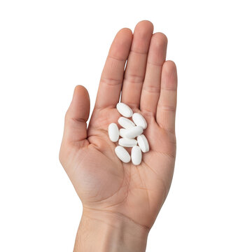 Person holding a handful of white medicine pills isolated on white background