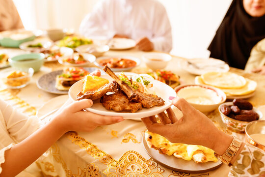 Family sharing festive meal around abundant dining table