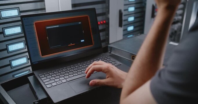 Male IT Specialist Responds To Cyber Attack Alert Using Linux Command Line, Reviewing Telemetry and Performing Emergency Recovery Actions During Critical Network Security Incident Within Data Center.