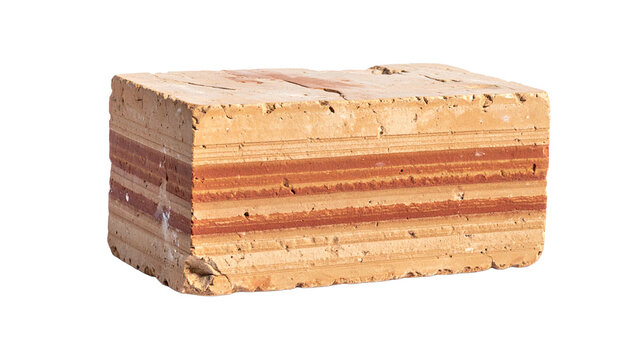 Close-up of a weathered brick with distinct red and beige layered patterns