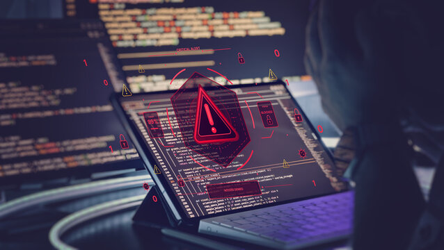 Cybersecurity threat concept: Hacker facing critical alert and access denied on computer screen.