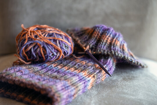 colorful ball of yarn and knitting needles
