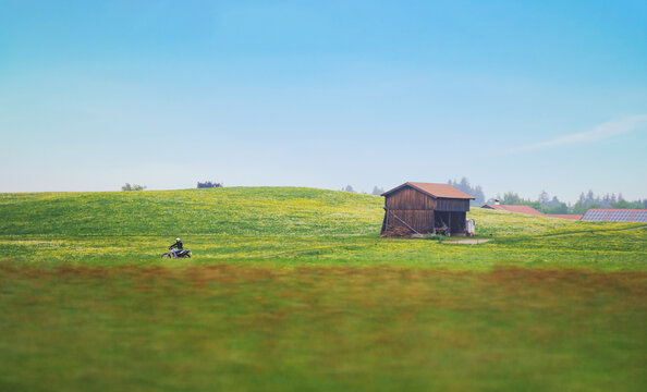 Europe countryside landscape, biker riding motorbike in summer
