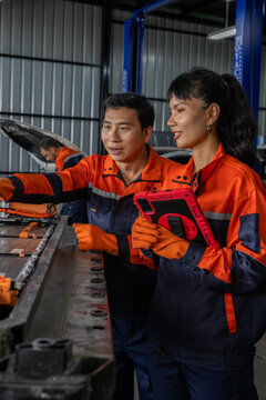 Industrial worker female engineer male technician factory machinery safety uniform tablet teamwork in industrial factory environment