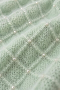 Soft Mint Green Knit Fabric with Pearl Embellishments Close up Texture