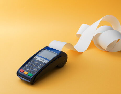 POS Terminal Printing Paper Receipt Roll on Bright Yellow Background
