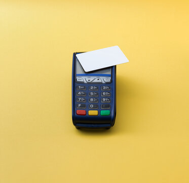 Blank White Credit Card Mockup on POS Terminal on Yellow Background