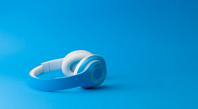 Blue Wireless Headphones on Matching Blue Background Monochromatic Shot
