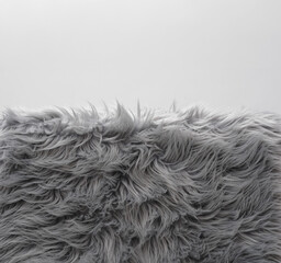 Soft grey faux fur carpet pile with copyspace background for home decor © stokkete