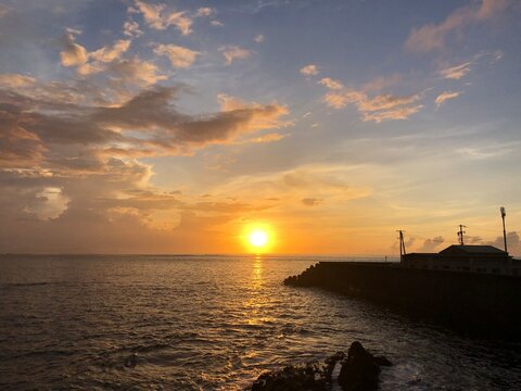 Golden sunset over the sea beside a harbor breakwater