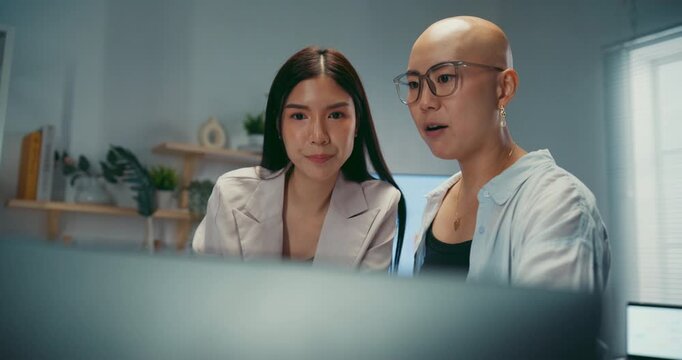 Young Asian business colleagues discussing project on computer at office. Corporate teamwork meeting, marketing report analysis, strategy planning development, professional manager advice concept.